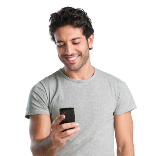 man smiles as he receives text